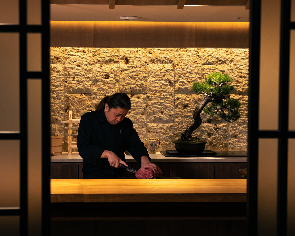 Chef Matoba cutting beef at the counter