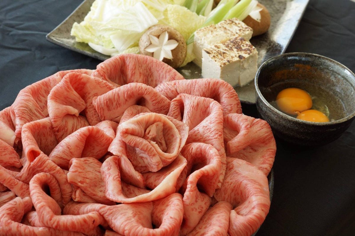 Ruffled raw slices beside a bowl of eggs and a platter of tofu and vegetables